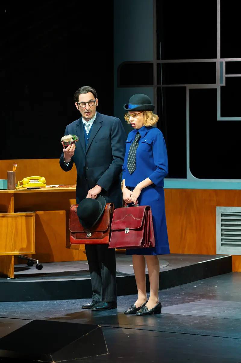 Actors in Blue and Navy on Theatrical Stage for "Miss Scrooge" Production