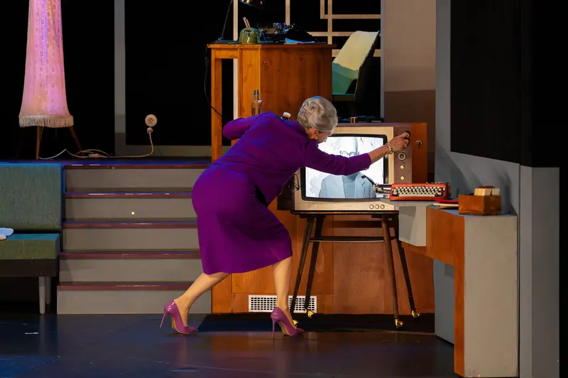 Miss Scrooge Adjusting Vintage Television at Theatrical Performance