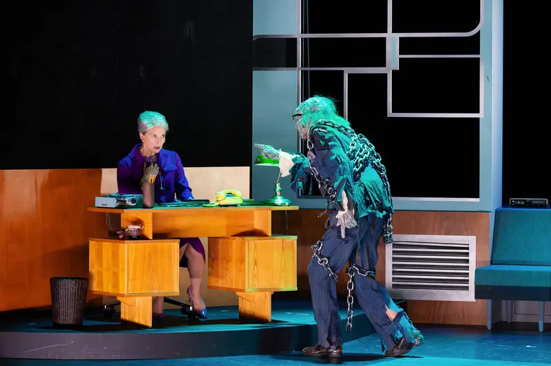 Ghostly Encounter in "Miss Scrooge" Theater Production at Kammerspielen