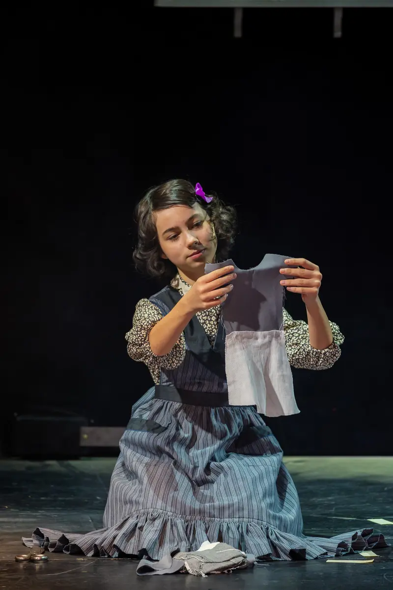Miss Scrooge in Contemplative Moment during Theatrical Performance at Kammerspielen