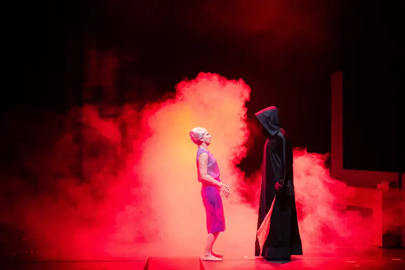 Theatrical Encounter with Death in Red Smoke during "Miss Scrooge" Performance