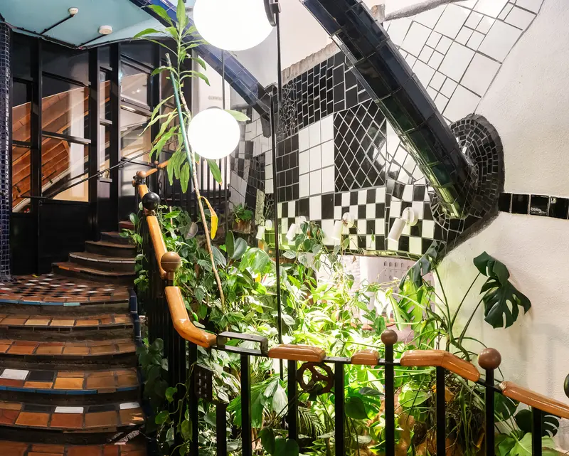 Interior Design with Curved Staircase, Lush Plants, and Geometric Tile Patterns