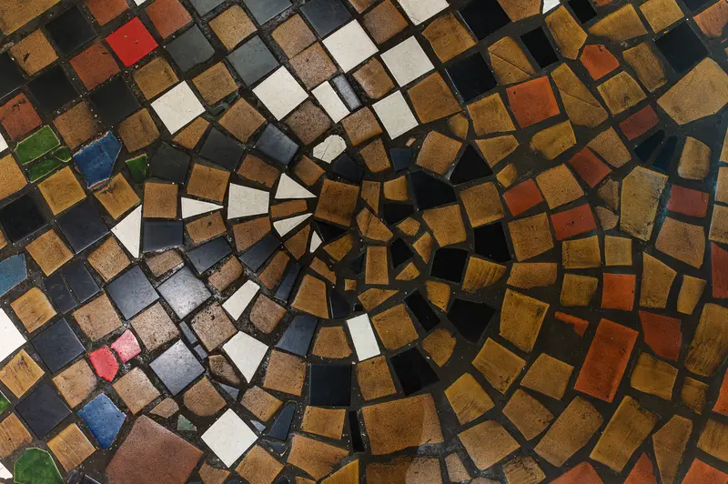 Intricate Geometric Mosaic with Varied Earth-Toned Ceramic Tiles in Spiral Pattern