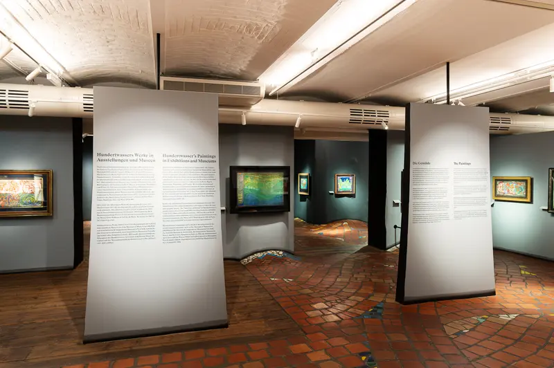 Gallery Interior with Informative Panels and Artwork at Museum Exhibition