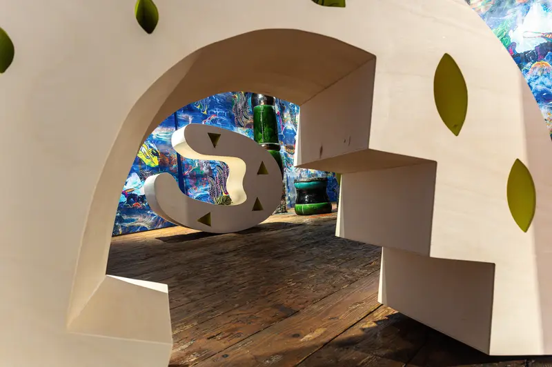 Architectural Installation with Sculptural Letter and Blue Background