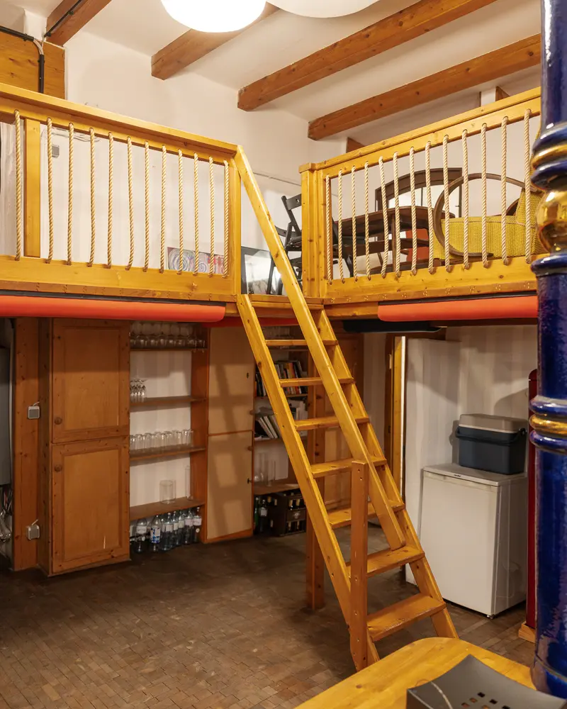 Wooden Loft Bed with Yellow Ladder in Compact Living Space