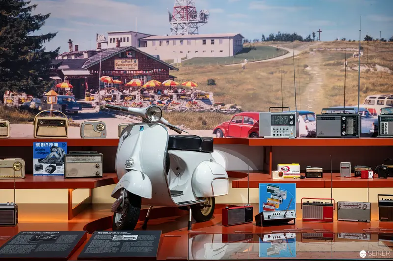 Vintage Radios and White Vespa Scooter in Technology Museum Display