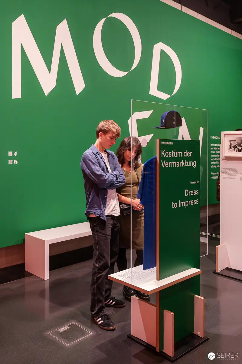 Wien Museum 'MIXED' Ausstellungseröffnung. Visitor Engaging with Interactive Display at Wien Museum's 'Mixed' Exhibition