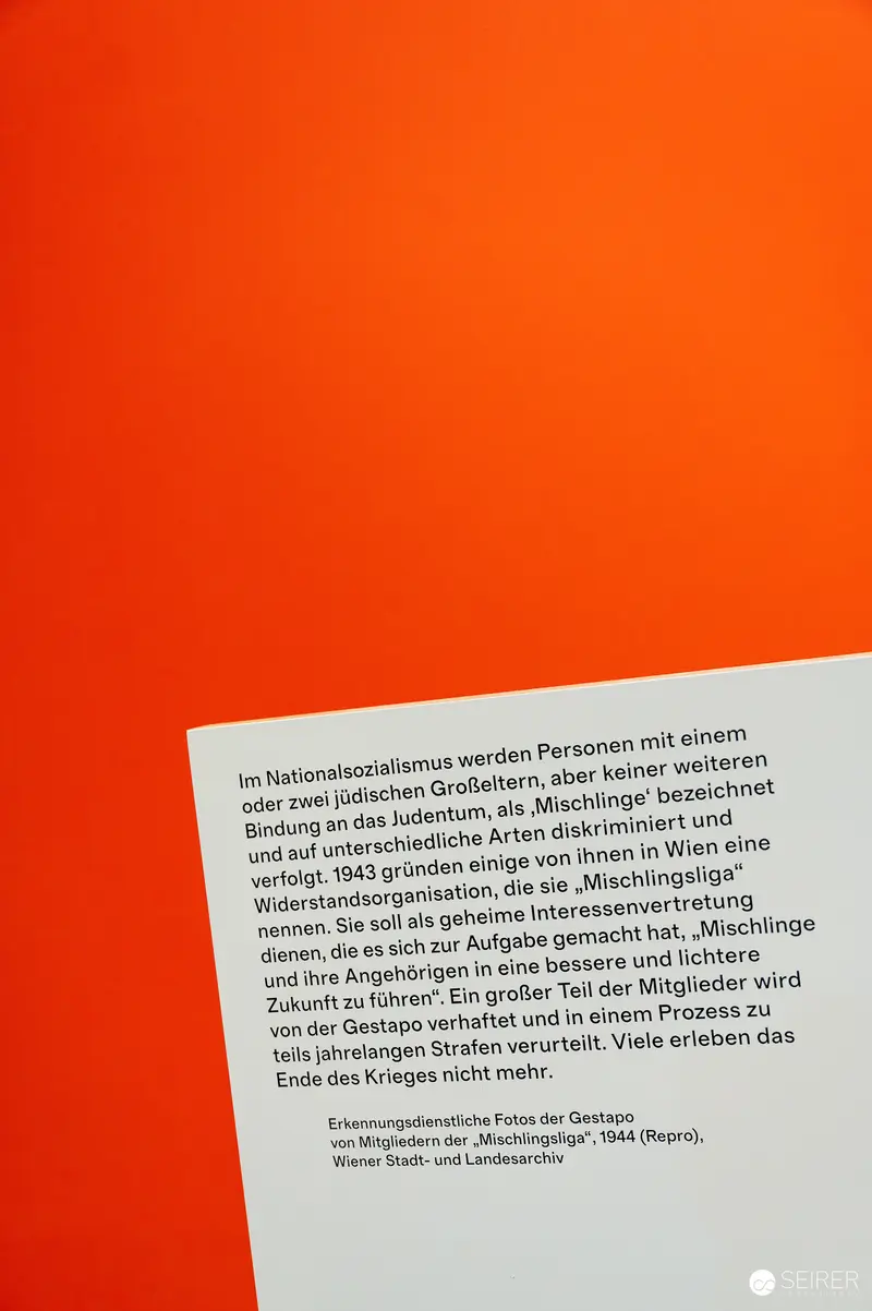 Wien Museum 'MIXED' Ausstellungseröffnung. Exhibition Text Panel on Orange Wall at Wien Museum 'Mixed' Exhibition