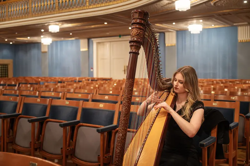 Harpist Performing Solo in Empty Concert Hall Before TU Orchestra Event