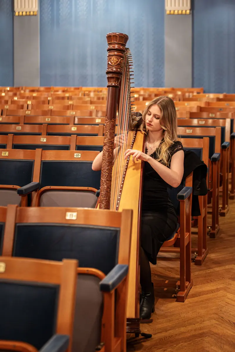 Harpist Performing Solo Amid Empty Concert Hall Seats
