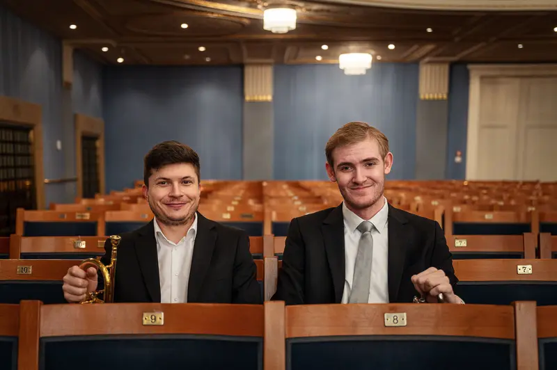 Two Young Musicians in Empty Concert Hall at TU Orchestra 40th Anniversary