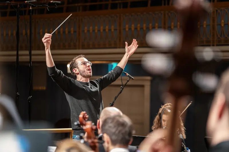 TU Orchestra Conductor Passionately Leads Performance at Konzerthaus Wien