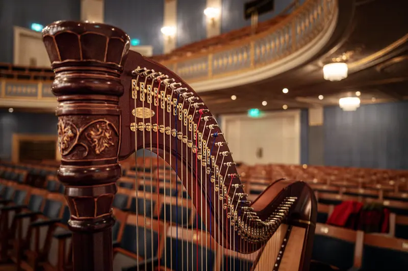 Ornate Concert Harp on Stage at Historic Performance Hall