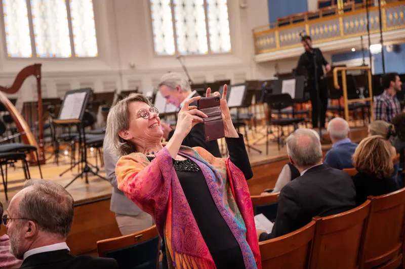 Audience Member Photographing TU Orchestra Performance at Vienna Concert Hall