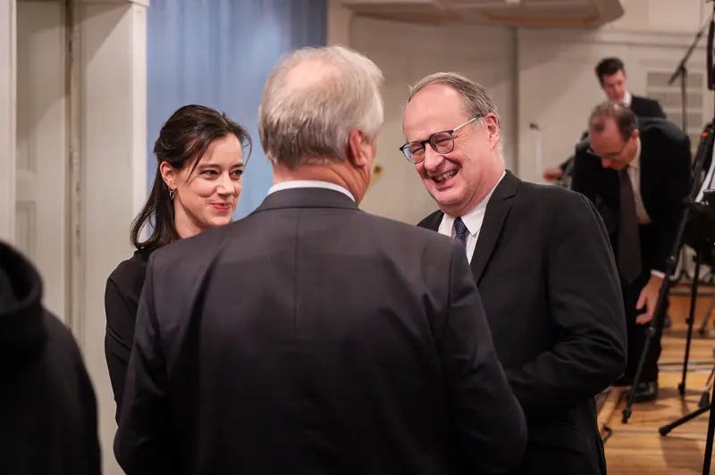 TU Orchestra Members Conversing at 40th Anniversary Event in Konzerthaus Wien