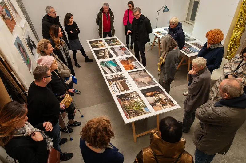 Visitors Examine Photographs at Elfie Semotan's Atelier During Foto Arsenal Event