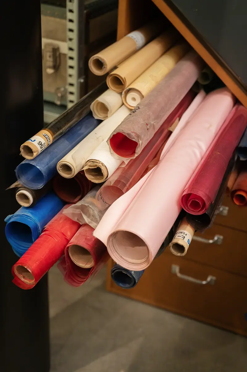 Colorful Architectural Drafting Rolls Stored in Wooden Filing Cabinet