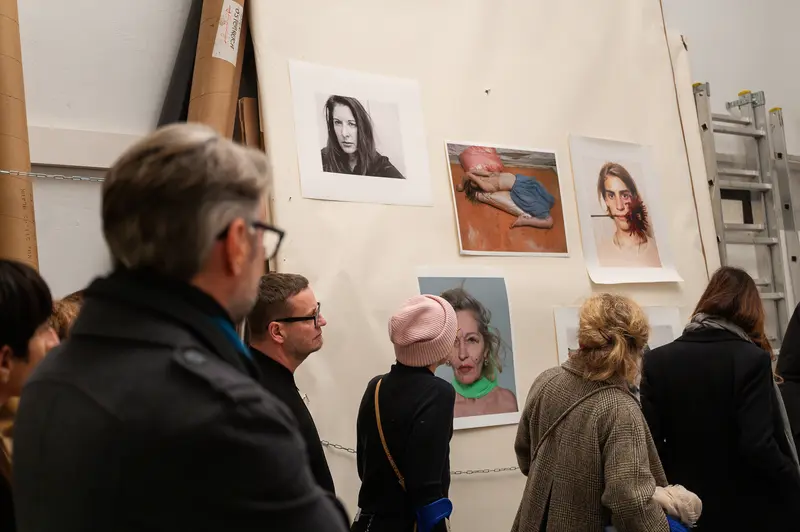 Visitors Exploring Portraits at Elfie Semotan's Atelier during Foto Arsenal Event