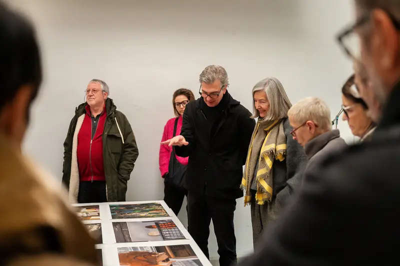 Visitors Examining Photographs at Elfie Semotan's Atelier During Foto Arsenal Event