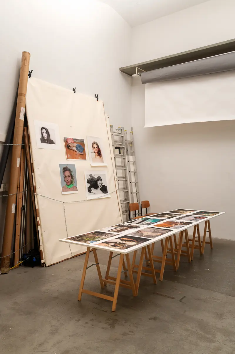Elfie Semotan's Photography Studio: Portraits and Images on Wooden Display Tables