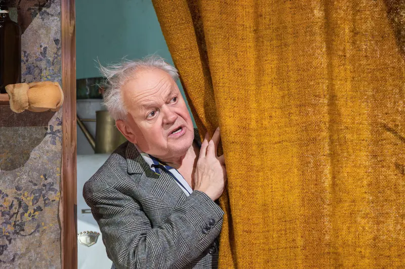 Behind the Curtain: Actor in Gray Blazer at Josefstadt Theater Rehearsal