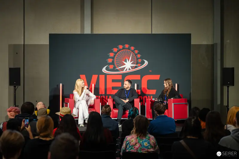 VIECC 2024 Panel Discussion with Guests on Red Chairs