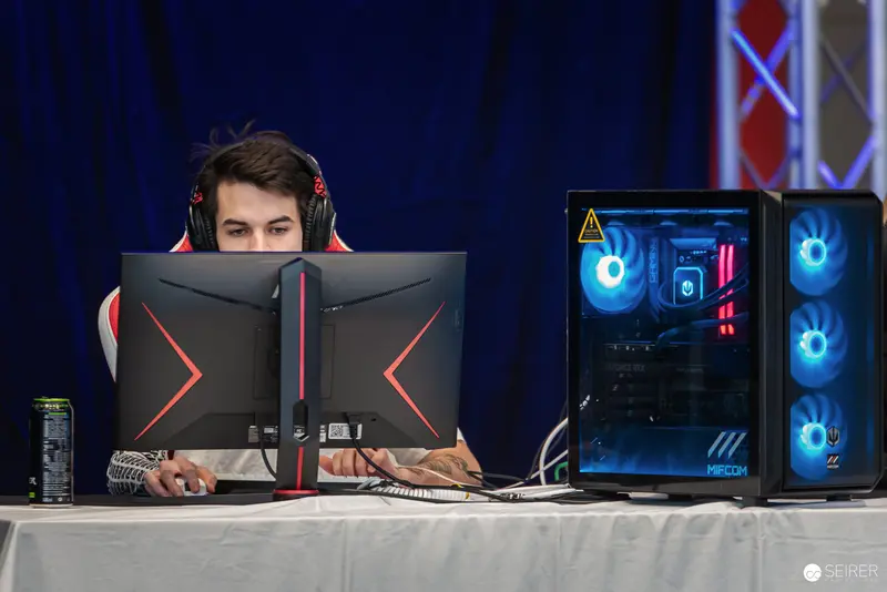 Professional Gamer at Gaming Setup with RGB Liquid-Cooled Gaming PC