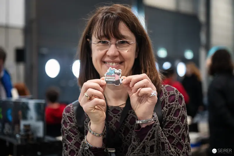 Attendee Smiling with Small Collectible at Vienna ComicCon 2024
