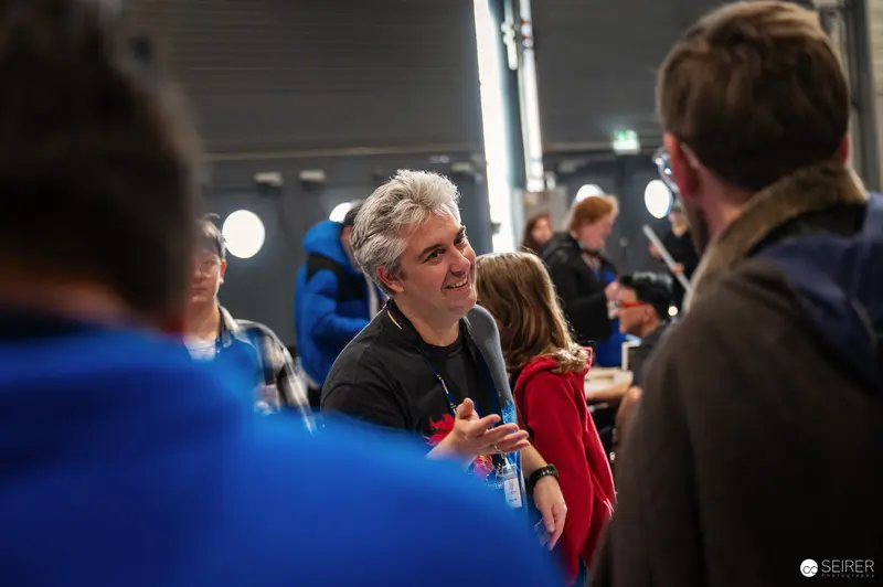 Attendees Conversing at Comic Convention in Indoor Event Space