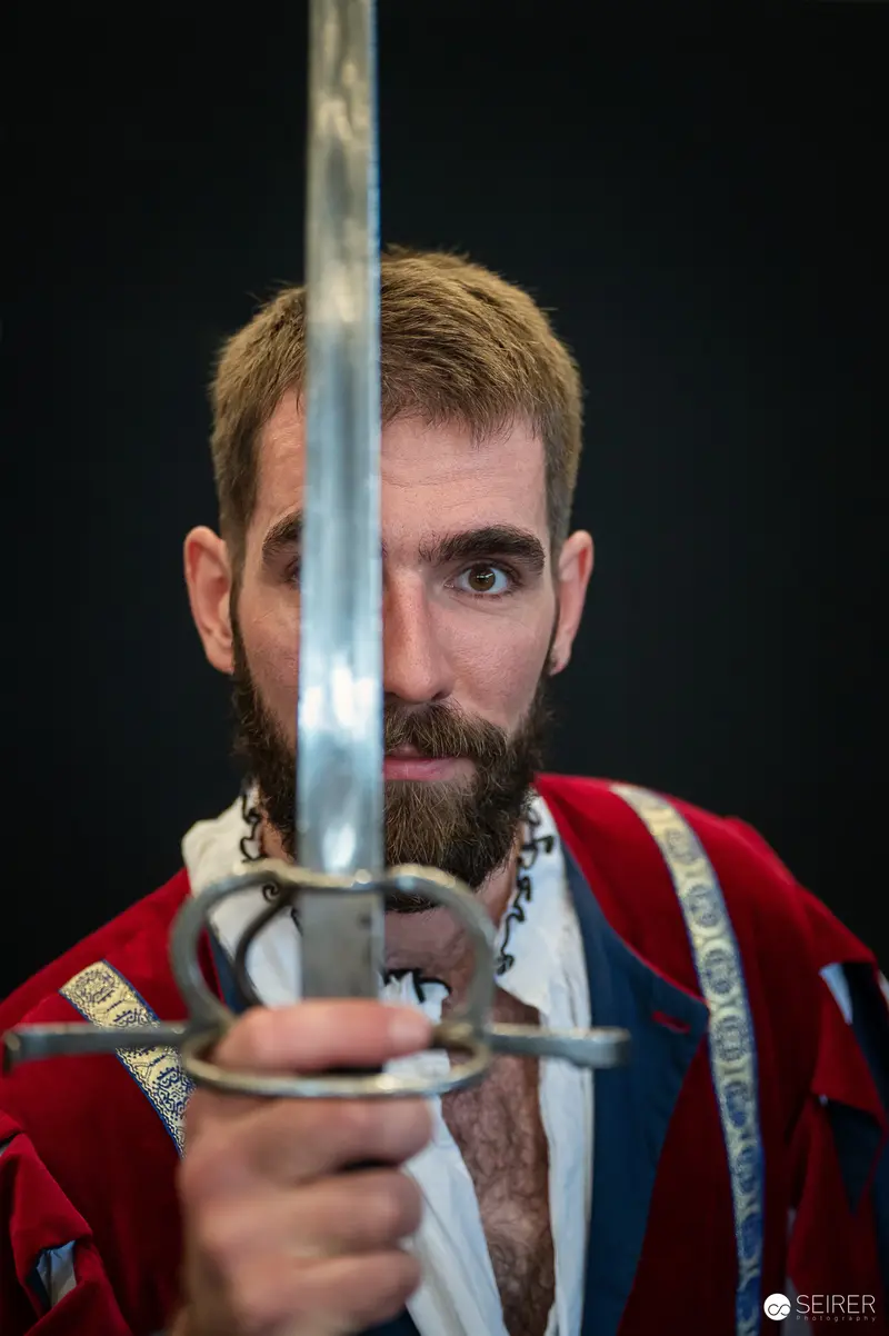 Medieval Sword Cosplayer in Dramatic Pose at Vienna ComicCon 2024