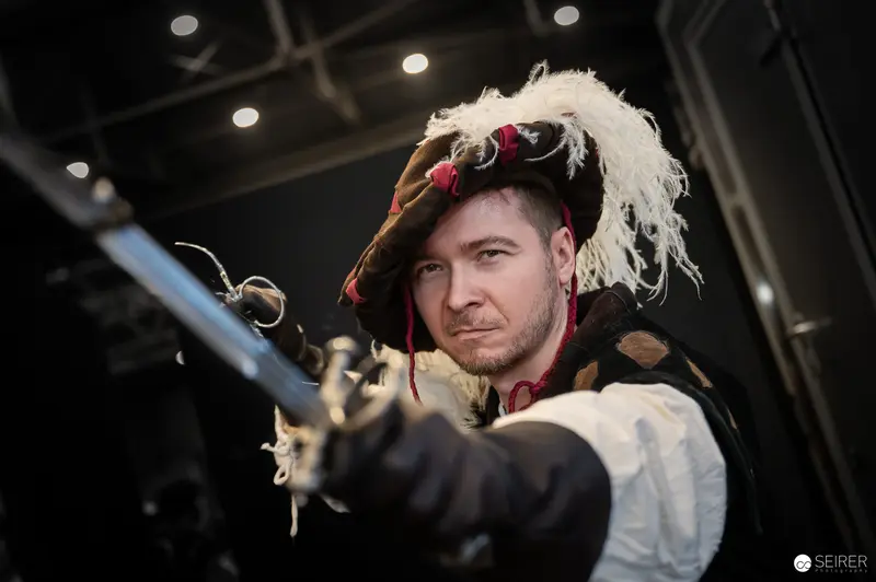 Costumed Performer with Feathered Hat and Musket at Vienna ComicCon 2024