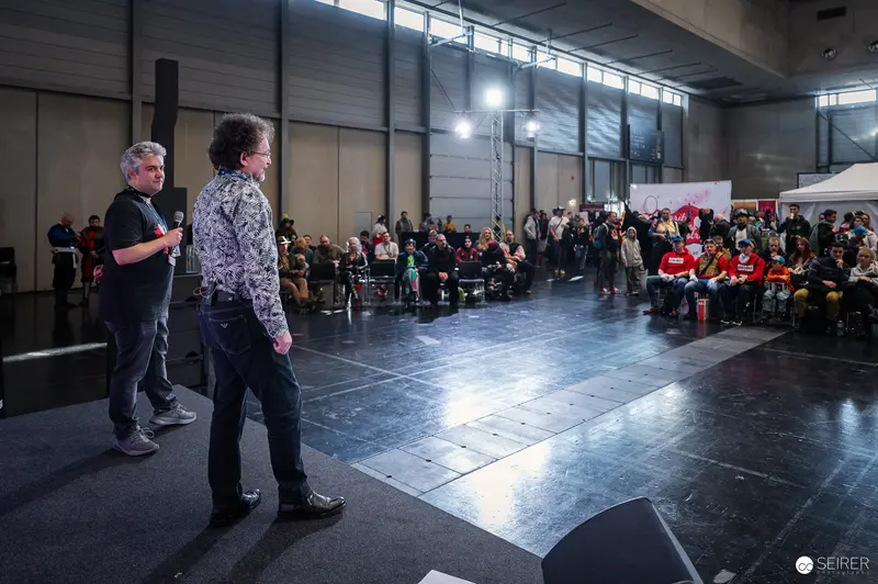 Presenters at Vienna ComicCon 2024 Addressing Audience in Convention Hall