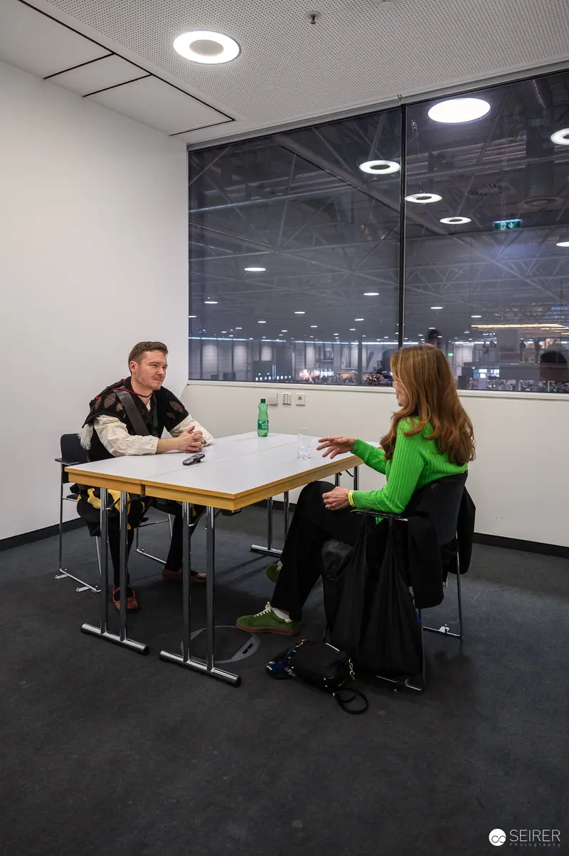 Two Attendees in Discussion at Vienna Workplace Interview Space