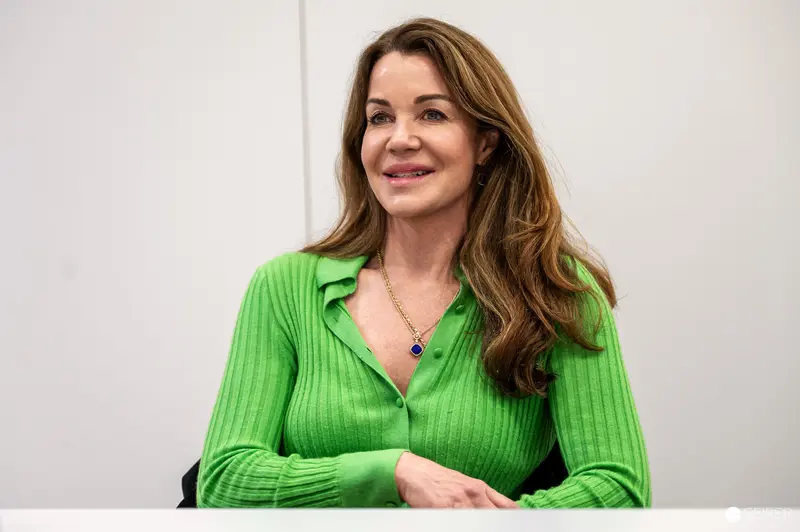Green-Clad Woman Smiling at Professional Event