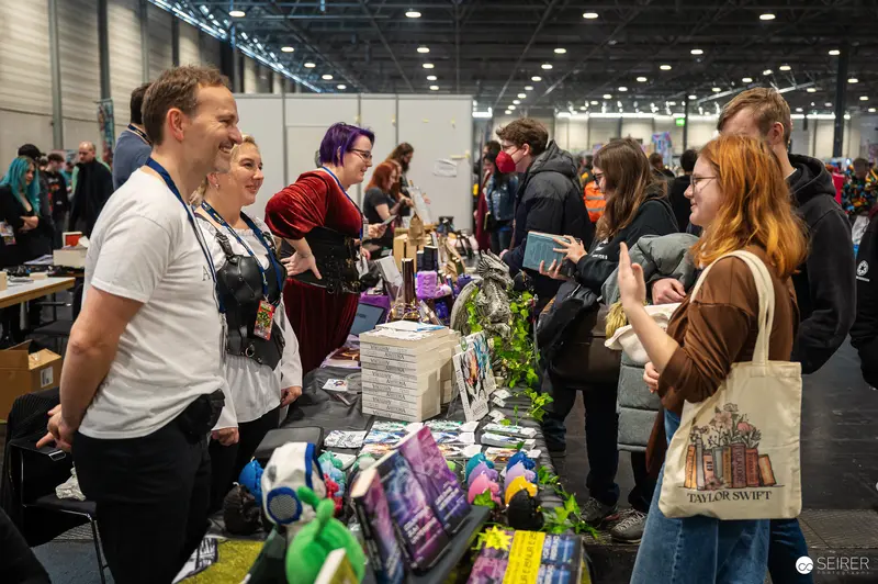 Vendors and Attendees at Vienna ComicCon 2024 Merchandise Booth