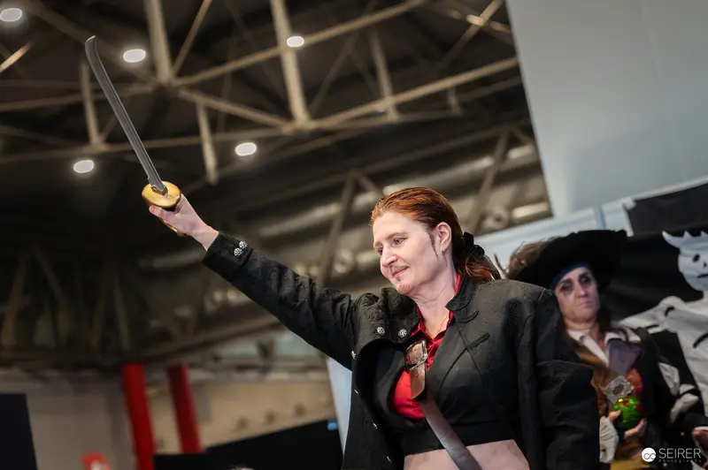 Cosplayer Wielding Sword at Vienna ComicCon 2024 Convention Hall