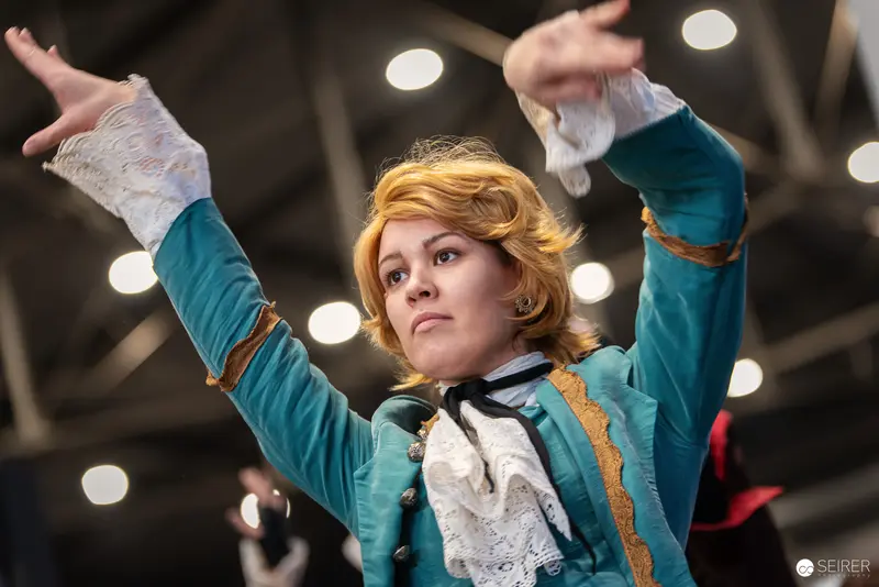 Cosplayer in Teal Baroque Costume Performs at Vienna ComicCon 2024