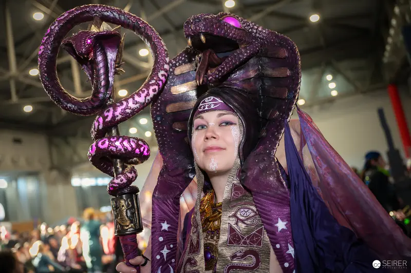 Cosplayer in Elaborate Purple Cobra Costume at Vienna ComicCon 2024