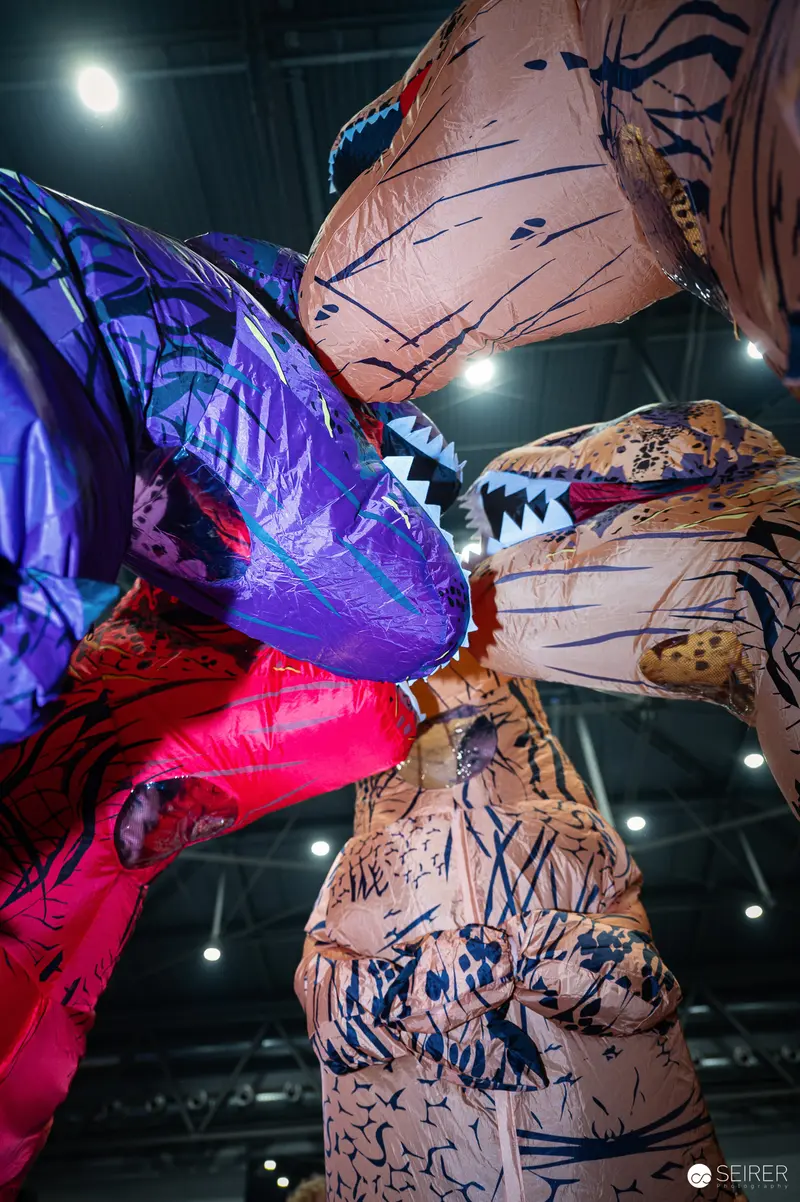 Inflatable Dinosaur Costumes Confronting at Vienna ComicCon 2024