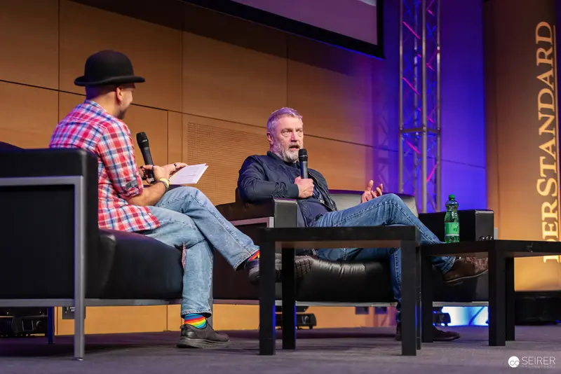Veteran Comedian in Plaid and Stripes at VIECC 2024 Panel Discussion