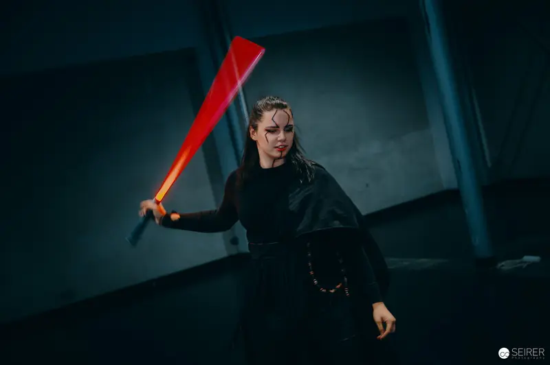 Cosplayer Wielding Glowing Red Lightsaber at Vienna ComicCon 2024