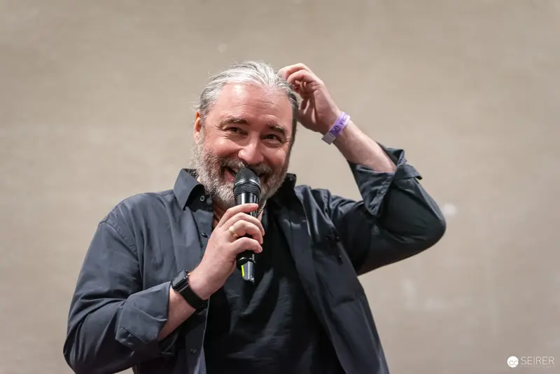 Comic Con Speaker Engaging Audience with Enthusiastic Microphone Performance
