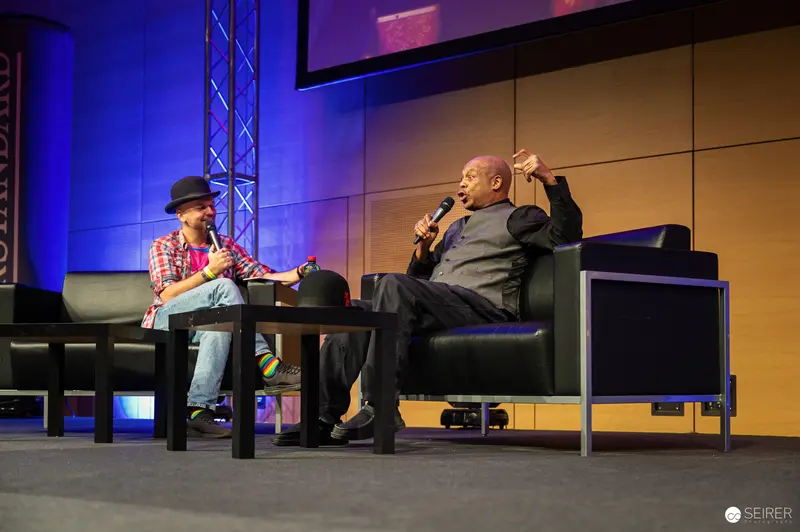 Comic Con Panel Discussion with Two Speakers on Stage in Vienna