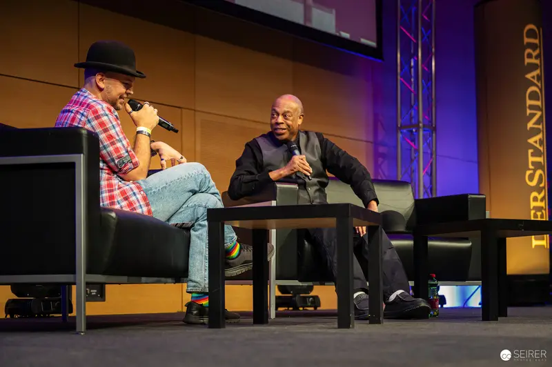 Two Speakers Discussing on Stage at Technology Conference