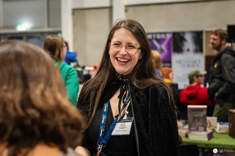 Smiling Attendee at Vienna ComicCon 2024 Convention Hall