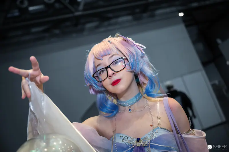 Cosplay Artist in Blue Wig Performing at Vienna ComicCon 2024