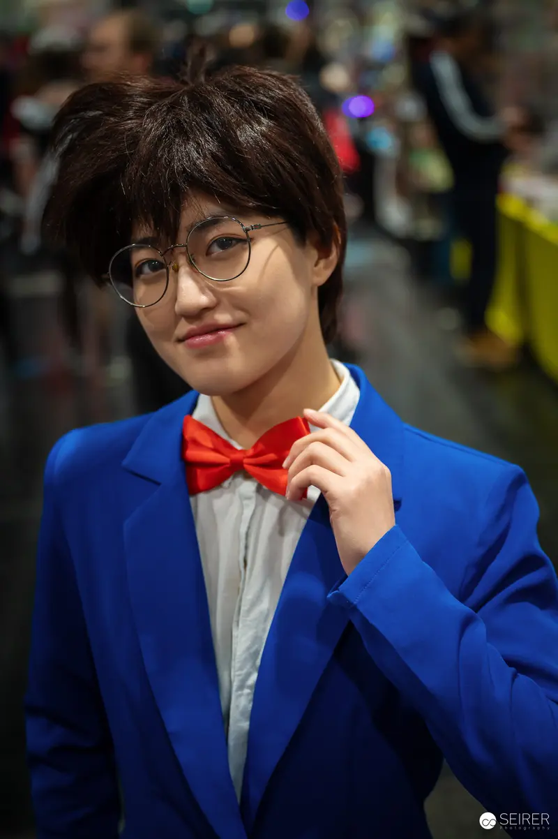 Cosplayer in Blue Blazer and Red Bowtie at Vienna ComicCon 2024