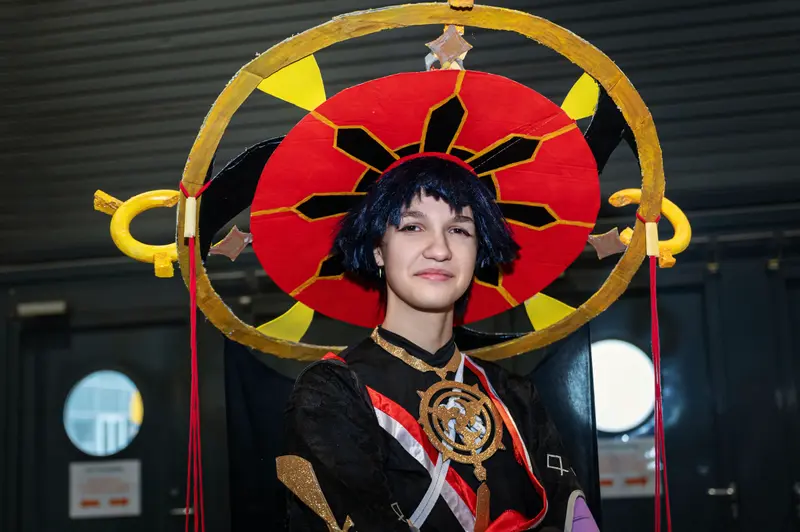 Cosplayer in Vibrant Sunburst Costume at Vienna ComicCon 2024