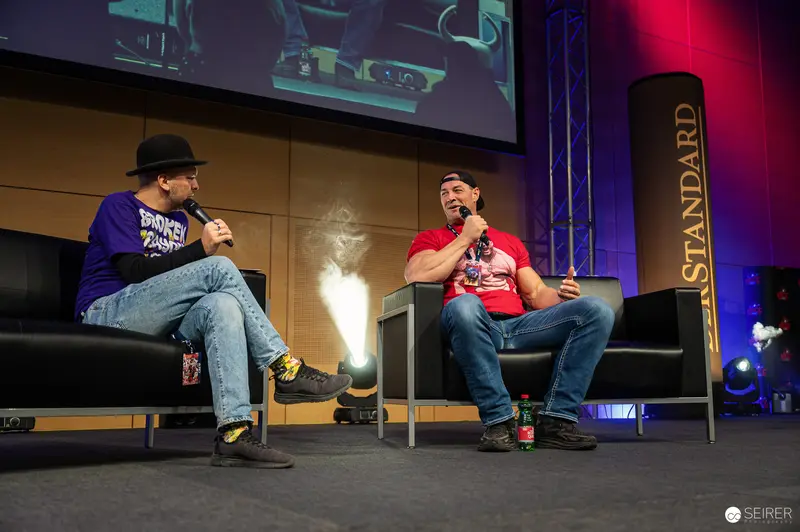 Comic Con Speakers Engage in Animated Discussion on Stage